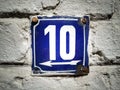 10 on grunge vintage house number plate on exterior wall. Royalty Free Stock Photo