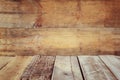 Grunge vintage wooden board table in front of old wooden background. Ready for product display montages Royalty Free Stock Photo