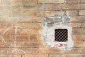 Grunge wall with a window with rusted iron grate Royalty Free Stock Photo