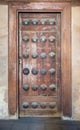 Grunge wooden aged door on grunge stone wall