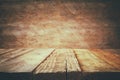 Grunge wooden board table in front of old wooden background