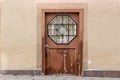 Grunge wooden door with hexagonal glass window