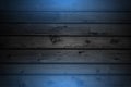 Grunge wooden planks with blue neon illumination abstract background