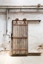 Grunge wooden roller door in prison cell. Royalty Free Stock Photo