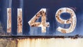 Grunge worn rusty metal background with chipped and faded painted numbers