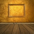 Grungy amber room with frame and spotlight Royalty Free Stock Photo