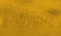 Grungy background wall in concrete or cement painting of gold yellow, dirty texture