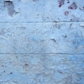 Grungy blue painted cracked part of outside wall