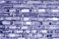 Grungy blue toned brick house wall.