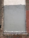 Grungy brick wall with frame and cement Royalty Free Stock Photo