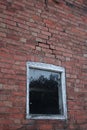 Grungy building with visible subsidence, with weathered window frame Royalty Free Stock Photo