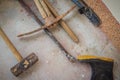 Grungy construction tools such as rubber boot, hammer, crowbar,