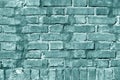 Grungy cyan toned brick wall texture.