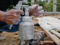 A grungy dirty paint sprayer in hands of a painter about to be opened and refilled to get it ready for the next round of spraying Royalty Free Stock Photo