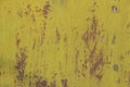 Grungy metal background painted with bright greeny yellow rusted and peeling with gunk stuck on it Royalty Free Stock Photo