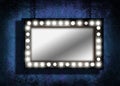 A grungy mirror with marquee lights