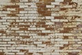 Grungy old exterior clay brick wall texture background with worn white paint Royalty Free Stock Photo