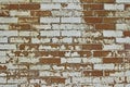 Grungy old exterior clay brick wall texture background with worn white paint Royalty Free Stock Photo