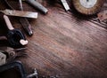 Grungy old tools on a wooden background