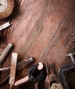 grungy old tools on a wooden background (processing cross-process)
