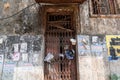 The grungy rusted metal shutters of an old decaying building in the city of Madgaon