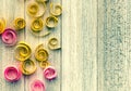 Grungy rustic background with paper spirals and swirls on a weathered wooden table