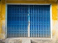 Grungy rusty blue and yellow metal gate