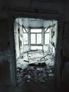 Grungy shot of ruined gazebo with leaning door and shelf