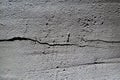 Grungy texture of gray plaster made from  mixture of concrete, deep scratches, cement and small stones. wall texture background Royalty Free Stock Photo