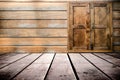 Grungy textured red brick and stone wall with warm brown wooden floor inside old neglected and deserted interior, masonry and carp