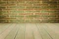 Grungy textured red brick and stone wall with warm brown wooden floor inside old neglected and deserted interior, masonry and carp Royalty Free Stock Photo