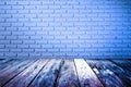 Grungy textured red brick and stone wall with warm brown wooden floor inside old neglected and deserted interior, masonry and carp Royalty Free Stock Photo