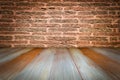 Grungy textured red brick and stone wall with warm brown wooden floor inside old neglected and deserted interior, masonry and carp Royalty Free Stock Photo