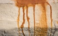 Grungy wall background with red rusty stain dripping down from corrosion