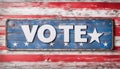 Grungy wood board with VOTE word for US elections