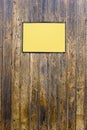 Grungy wood texture with a yellow sign