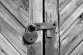 Grungy wooden door with lock in black and white Royalty Free Stock Photo