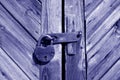 Grungy wooden door with lock in blue tone Royalty Free Stock Photo