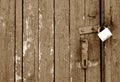 Grungy wooden door with lock in brown tone Royalty Free Stock Photo