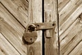 Grungy wooden door with lock in brown tone Royalty Free Stock Photo