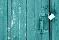 Grungy wooden door with lock in cyan tone Royalty Free Stock Photo