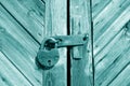 Grungy wooden door with lock in cyan tone Royalty Free Stock Photo