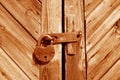 Grungy wooden door with lock in orange tone Royalty Free Stock Photo