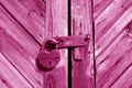 Grungy wooden door with lock in pink tone Royalty Free Stock Photo