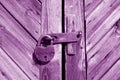 Grungy wooden door with lock in purple tone Royalty Free Stock Photo