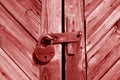 Grungy wooden door with lock in red tone Royalty Free Stock Photo