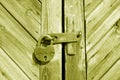 Grungy wooden door with lock in yellow tone Royalty Free Stock Photo