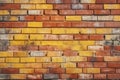 Grungy yellow and red brick wall as a seamless pattern background.