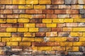 Grungy yellow and red brick wall as a seamless pattern background.