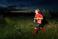 GRUNIVKA, SUMY REGION, UKRAINE - JUNE 20, 2021: Sportsman running through the field on night race of SKIF Cup XIV sports